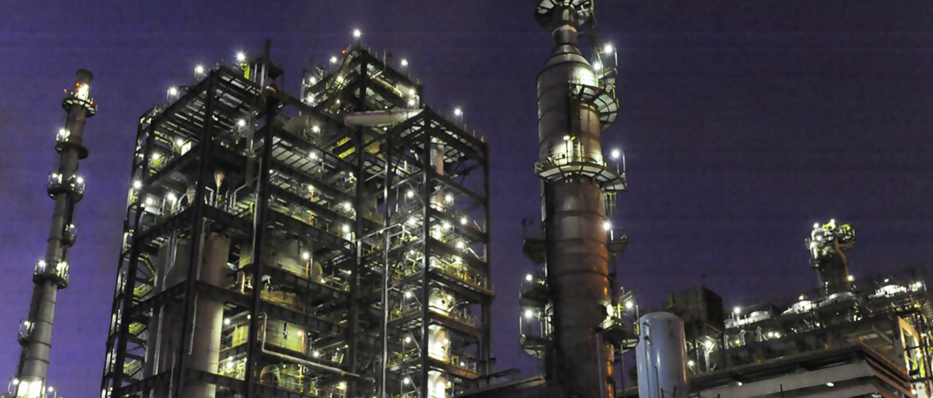 Illuminated process towers at a refinery